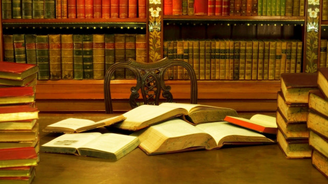 Pile of books table chair free wallpaper - medium preview image