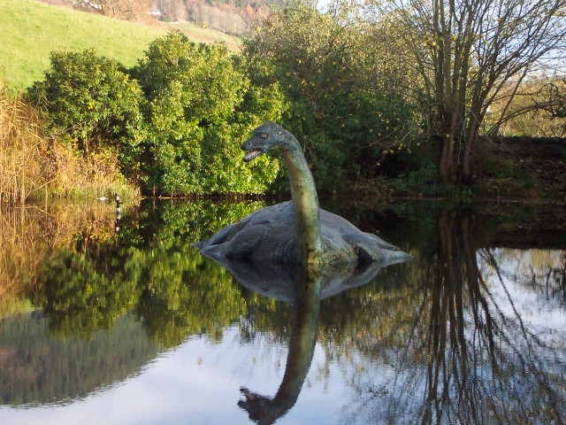 Dinosaur statue lake trees hill free wallpaper - medium preview image