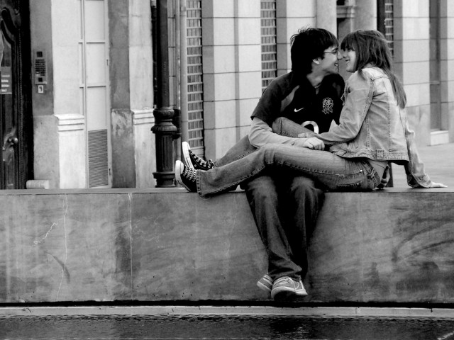 Man woman kissing ledge building free wallpaper - medium preview image