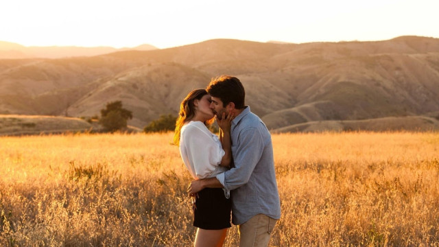 Man woman kissing field grass #3 free wallpaper - medium preview image