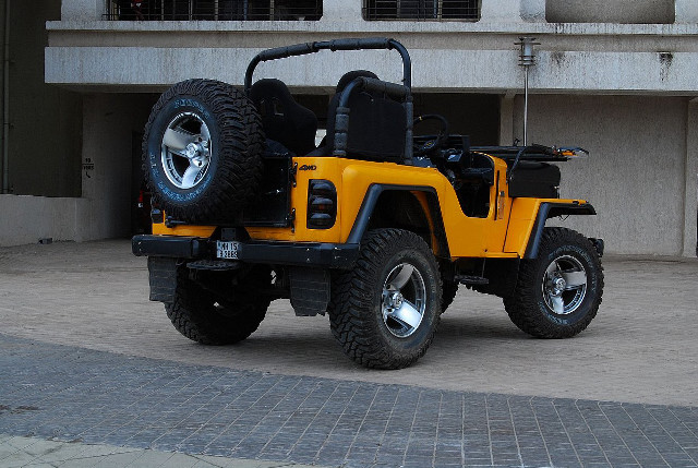 Yellow jeep parked building large free wallpaper - medium preview image