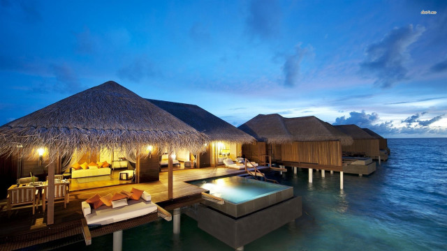 Resort pool thatched huts night free wallpaper - medium preview image