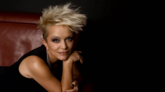 Blonde woman red couch hand free wallpaper - medium preview image
