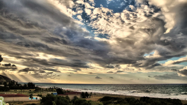 Cloudy sky beach house ocean free wallpaper - medium preview image