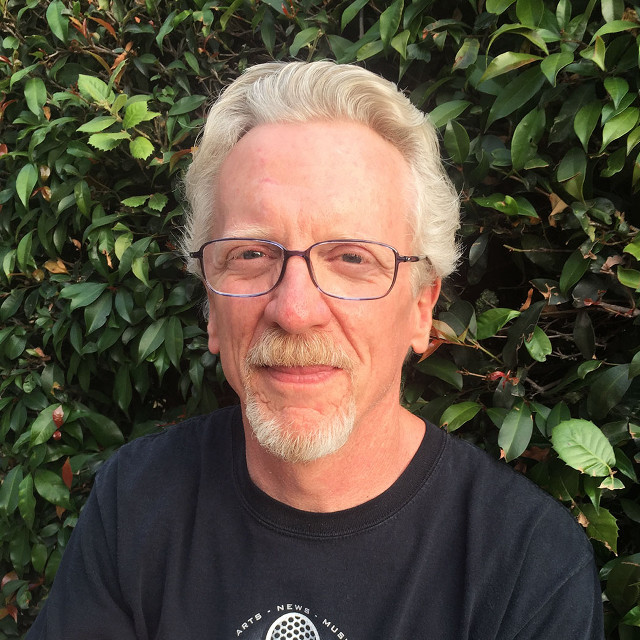 Man with glasses beard holding free wallpaper - medium preview image