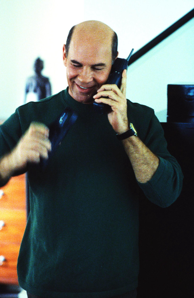 Man talking cell phone room free wallpaper - medium preview image