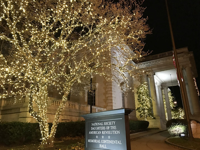 Sign tree lit building night free wallpaper - medium preview image