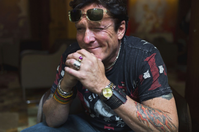 Tattooed man smiling ring portrait free wallpaper - medium preview image