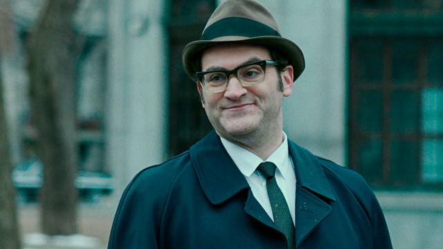 Man green coat hat building free wallpaper - medium preview image