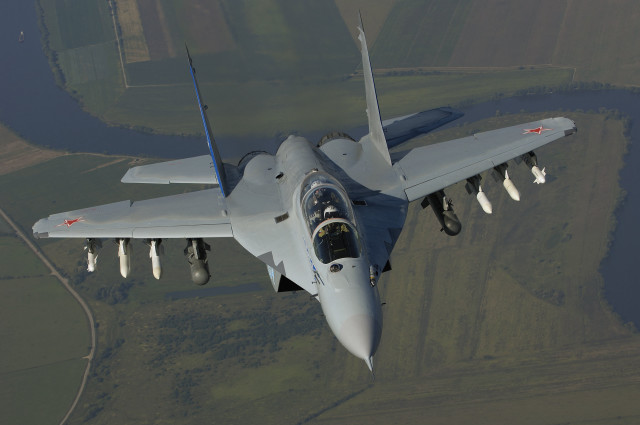 Fighter jet lush green field #2 free wallpaper - medium preview image