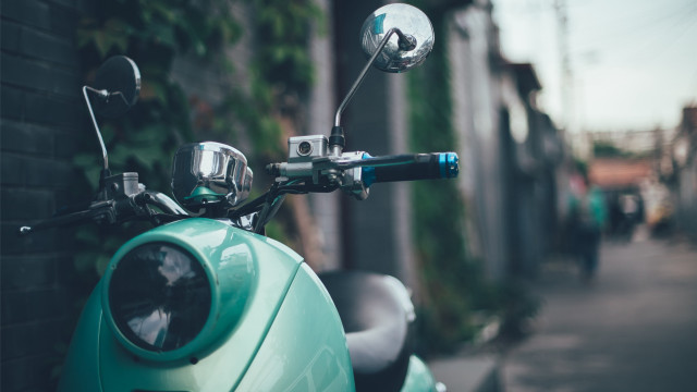 Blue scooter parked building sidewalk free wallpaper - medium preview image