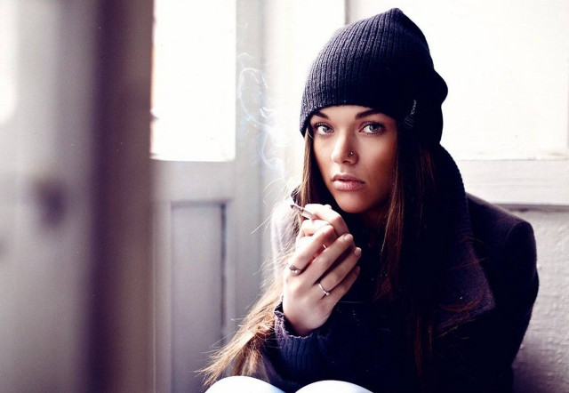 Woman sitting couch cigarette hand free wallpaper - medium preview image