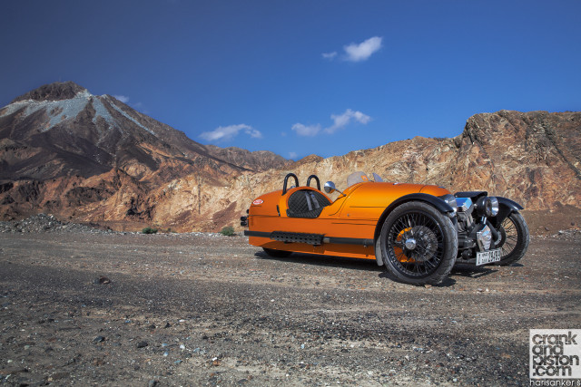 Orange motorcycle mountain range sky free wallpaper - medium preview image