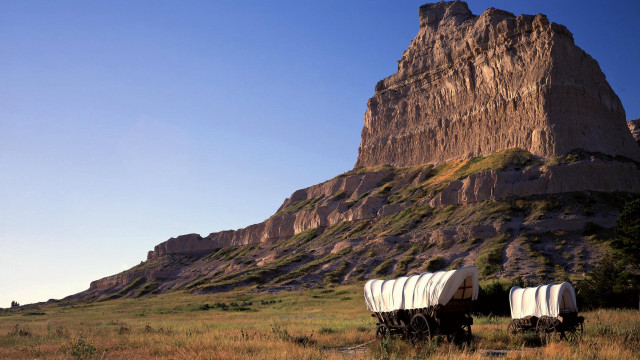 Covered wagons field mountain rock free wallpaper - medium preview image