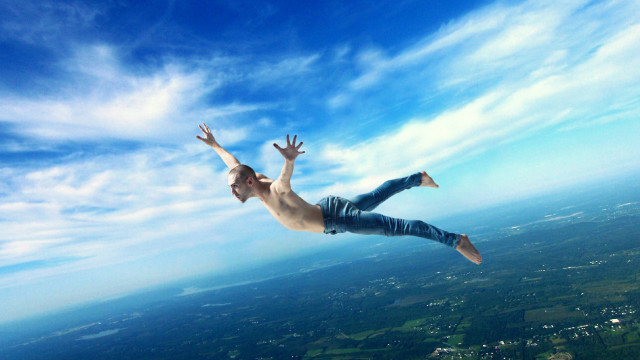 Man flying arms outstretched hands free wallpaper - medium preview image
