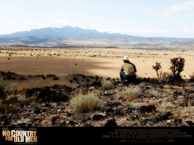 Man sitting hill desert landscape free wallpaper - medium preview image