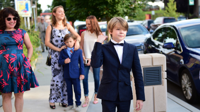 Young boy tuxedo bowtie walking free wallpaper - medium preview image