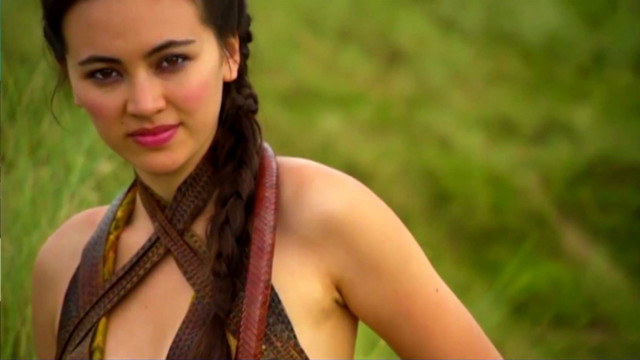 Woman braids grassy field camera free wallpaper - medium preview image