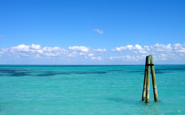 Wooden pole ocean sky clouds free wallpaper - medium preview image