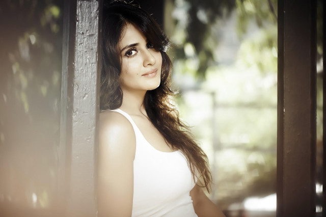 Woman white top leaning wall #6 free wallpaper - medium preview image