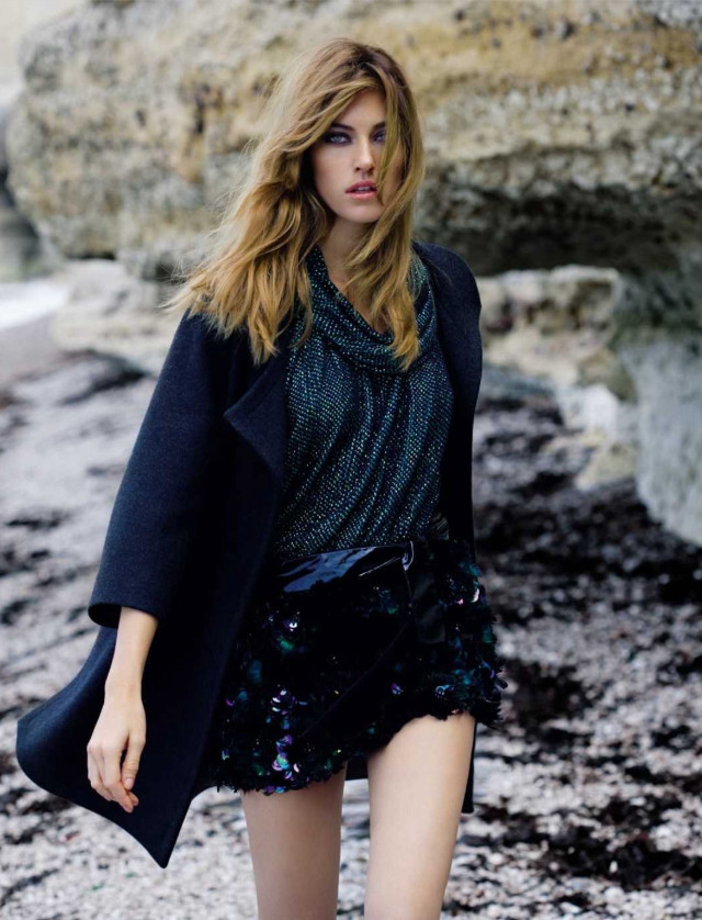 Woman walking rocky beach coat free wallpaper - medium preview image