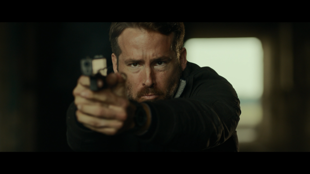 Man pointing gun serious expression free wallpaper - medium preview image