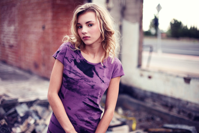 Woman standing junk brick wall free wallpaper - medium preview image