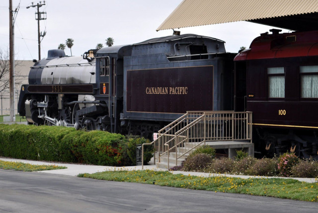 Train parked building sidewalk bench free wallpaper - medium preview image