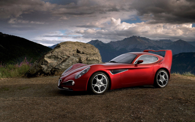 Red sports car mountain rock free wallpaper - medium preview image