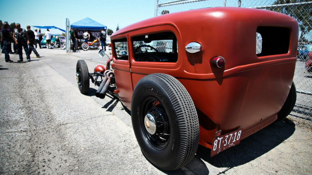 Red car parked road fence free wallpaper - medium preview image