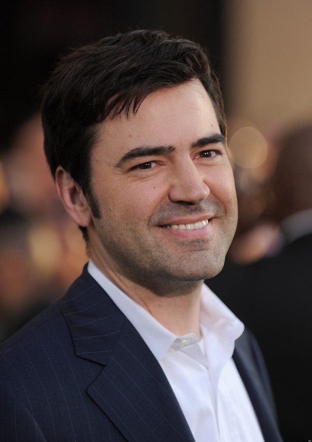 Man suit smiling camera blurry free wallpaper - medium preview image