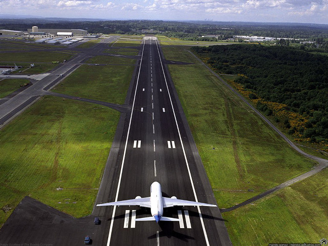 Jetliner airport runway lush green free wallpaper - medium preview image