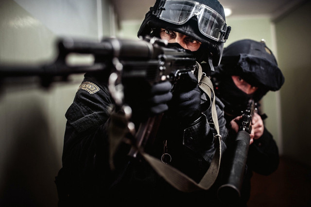 Man black jacket holding gun free wallpaper - medium preview image