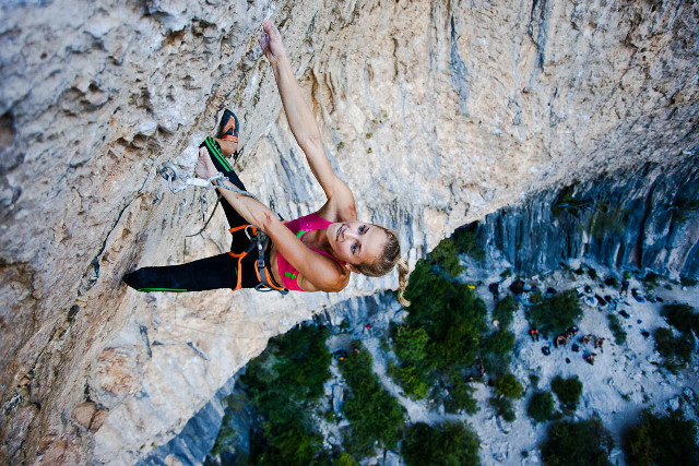 Woman climbing steep cliff rope free wallpaper - medium preview image