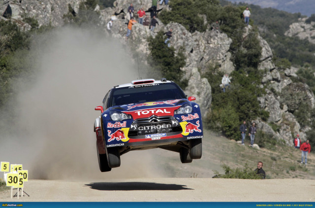 Rally car jumping hill crowd free wallpaper - medium preview image