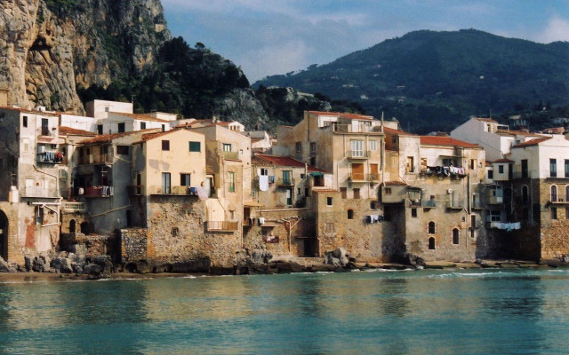 Buildings cliff ocean mountain background free wallpaper - medium preview image