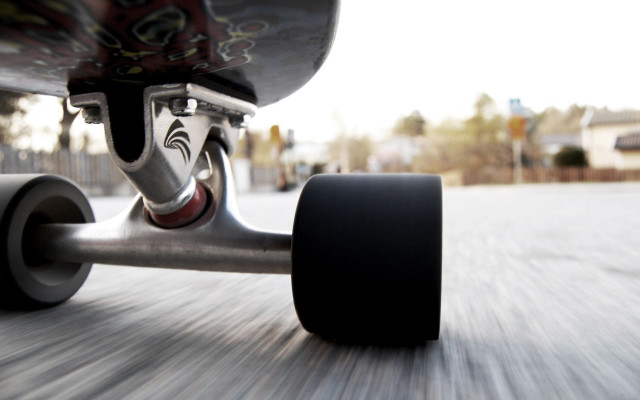 Skateboarder riding street wheels down free wallpaper - medium preview image