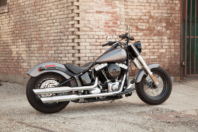 Motorcycle parked brick building green free wallpaper - medium preview image