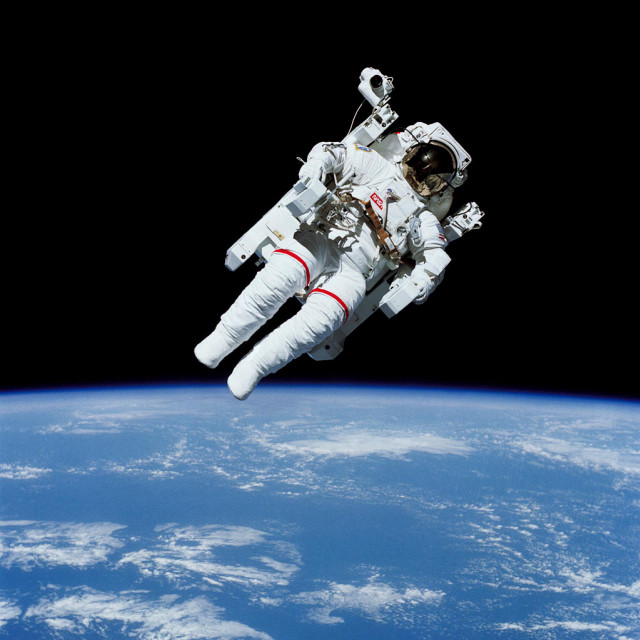 Astronaut floating above earth space free wallpaper - medium preview image