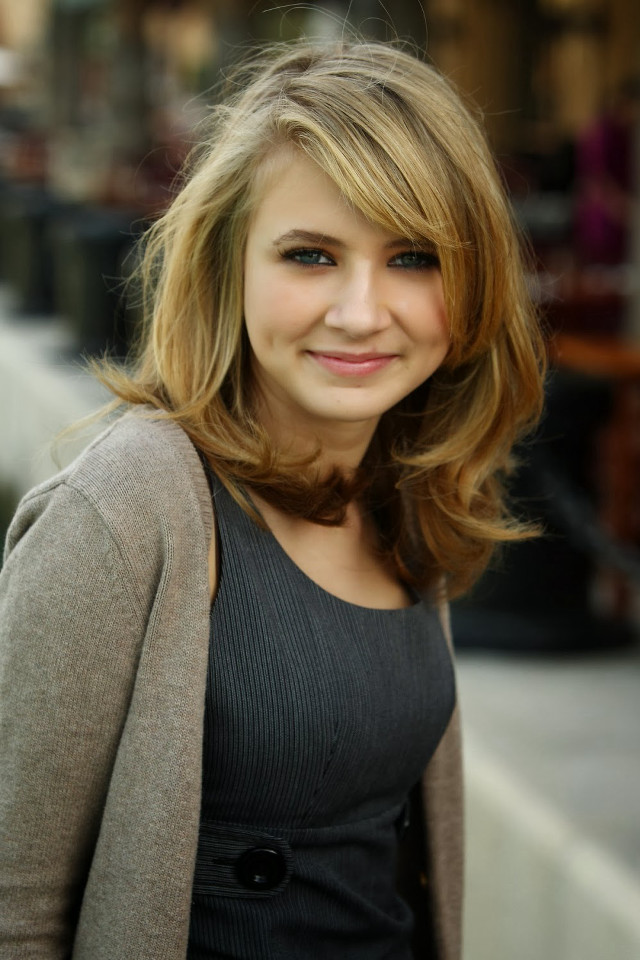 Smiling woman gray sweater black free wallpaper - medium preview image