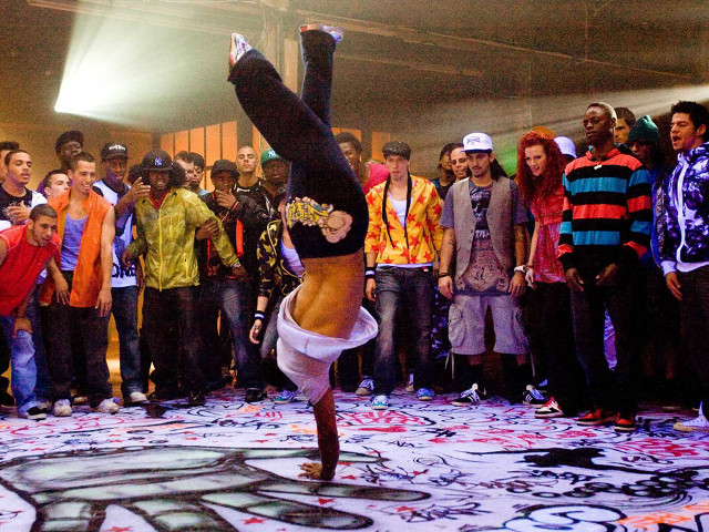 Woman handstand crowd building graffiti free wallpaper - medium preview image