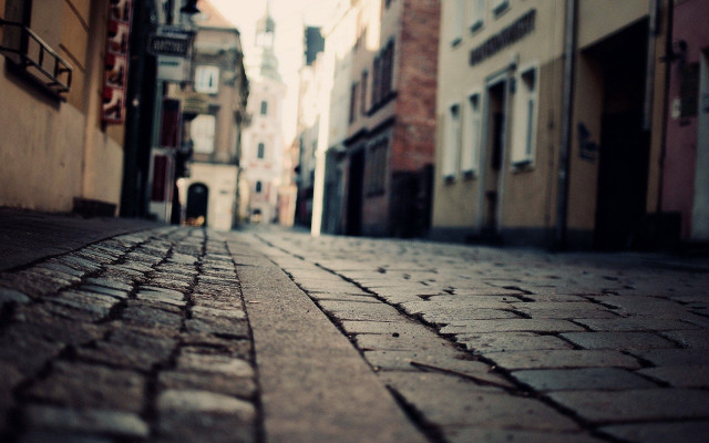 Person walking city street buildings free wallpaper - medium preview image