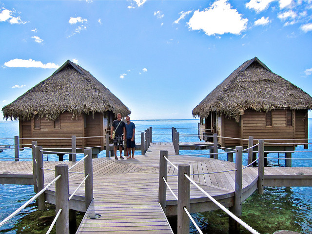 Couple people dock huts thatched free wallpaper - medium preview image