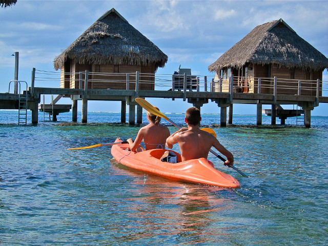 Kayak paddling towards pier thatched free wallpaper - medium preview image