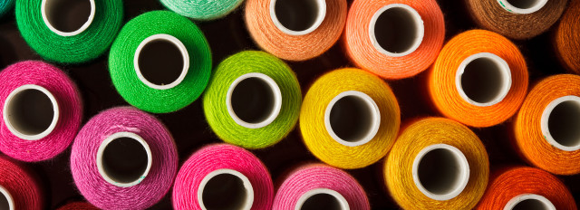 Colorful yarn spools stacked shelf free wallpaper - medium preview image