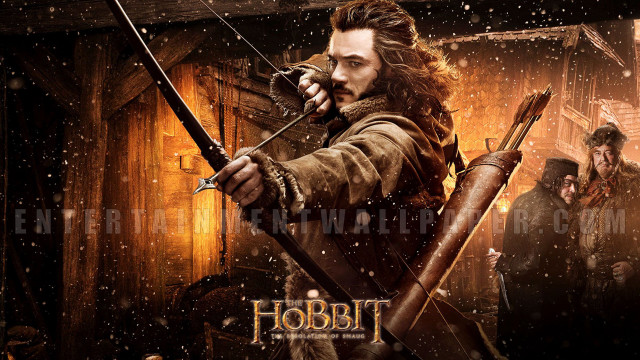 Man holding bow arrow snowy free wallpaper - medium preview image