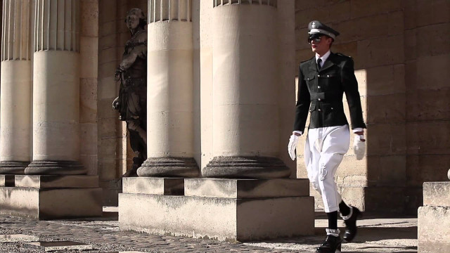 Man uniform walking street columns free wallpaper - medium preview image