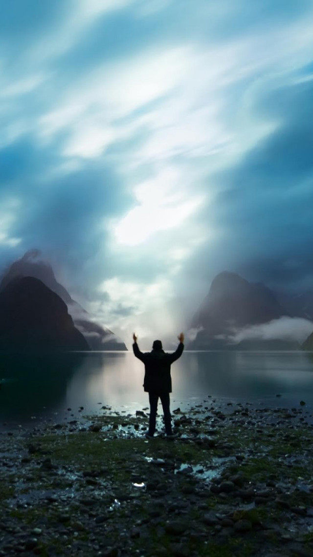 Man beach arms up mountains free wallpaper - medium preview image