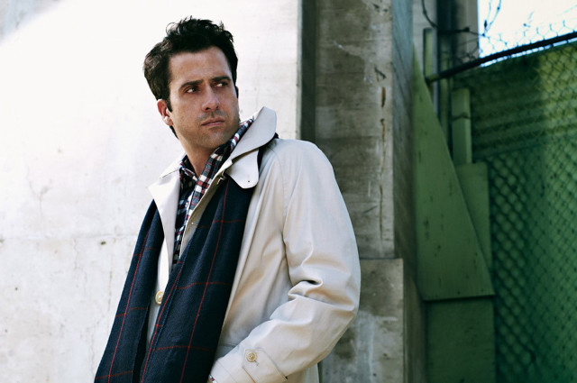 Man standing building scarf jacket free wallpaper - medium preview image