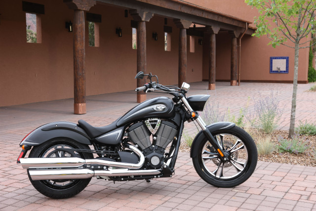 Motorcycle parked brick sidewalk building free wallpaper - medium preview image